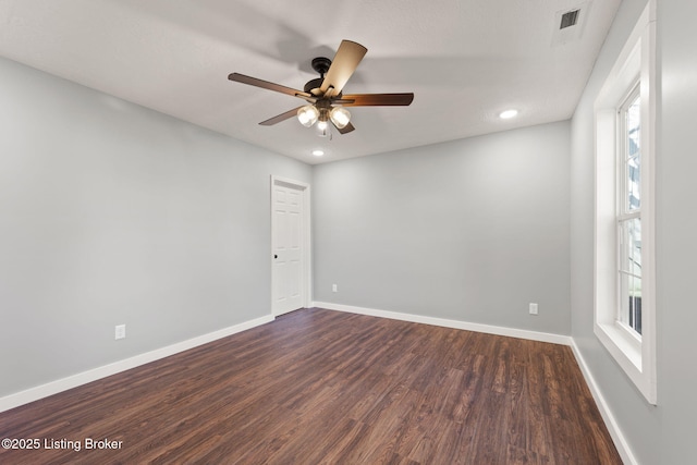 empty room featuring ceiling fan and dark hardwood / wood-style flooring