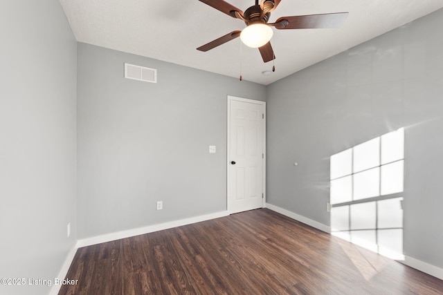 unfurnished room featuring dark hardwood / wood-style floors and ceiling fan