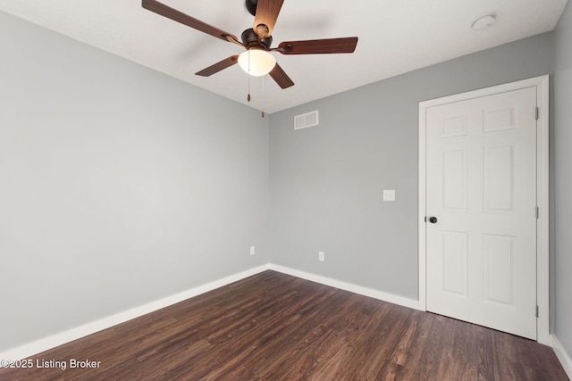 empty room with dark wood-type flooring and ceiling fan