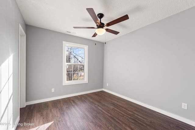 spare room with ceiling fan, dark hardwood / wood-style floors, and a textured ceiling