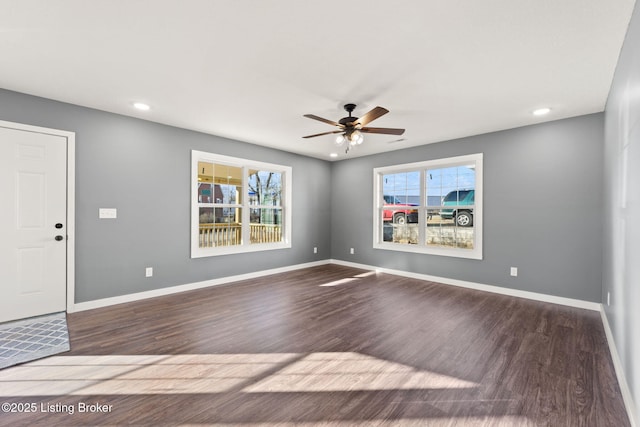 interior space with ceiling fan and dark hardwood / wood-style flooring