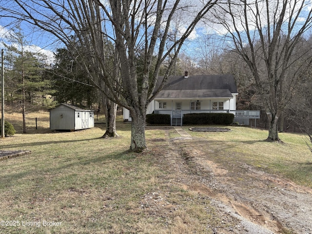 view of yard with a porch and a shed