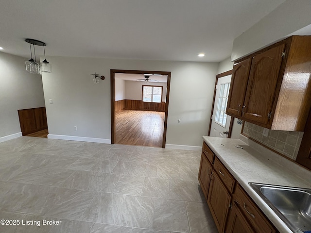 kitchen featuring pendant lighting, sink, and tasteful backsplash