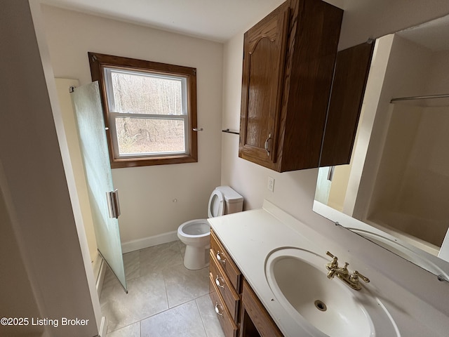 bathroom featuring vanity, walk in shower, tile patterned floors, and toilet