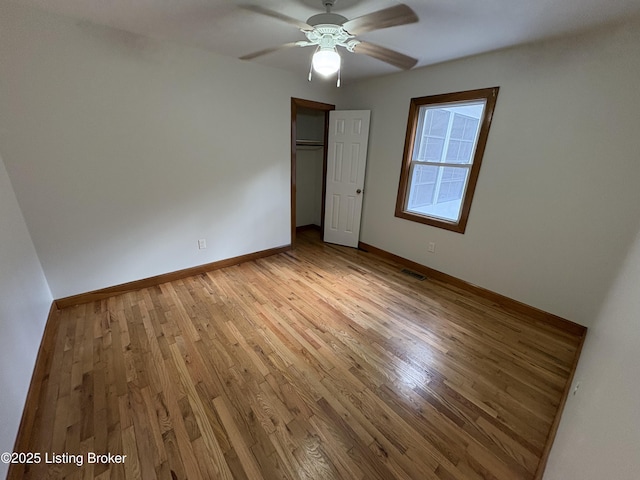 unfurnished bedroom with ceiling fan, a closet, and light hardwood / wood-style flooring