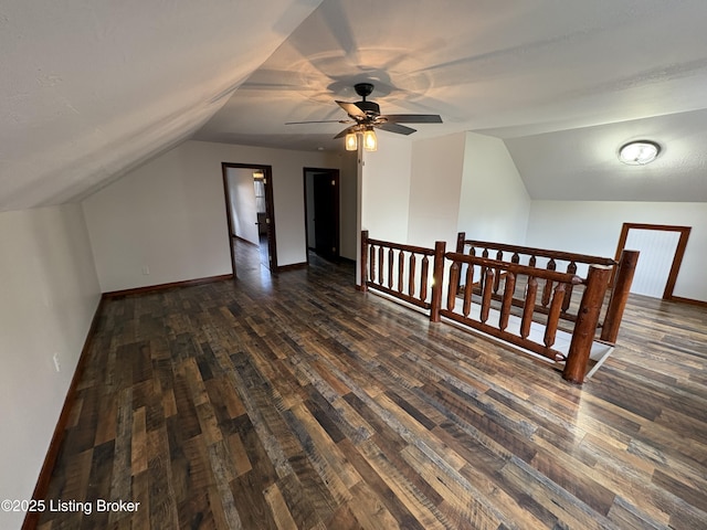 bonus room with dark hardwood / wood-style flooring and lofted ceiling