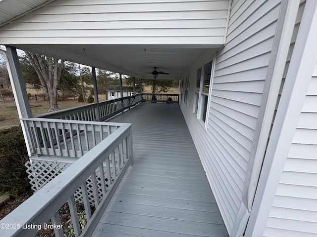 wooden terrace featuring ceiling fan