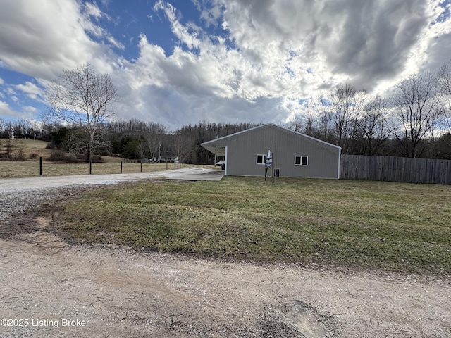 view of property exterior featuring a lawn and a carport