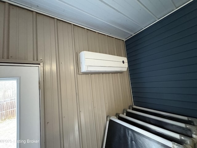 miscellaneous room with an AC wall unit and wood walls