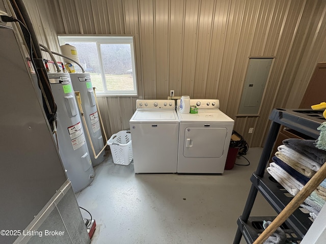 washroom with separate washer and dryer, wooden walls, electric panel, and water heater