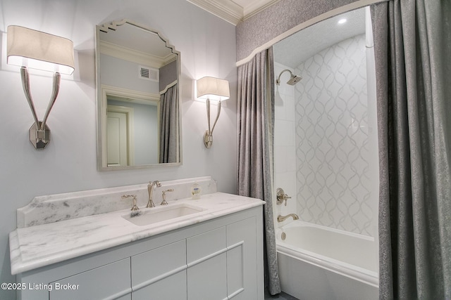 bathroom featuring vanity, tiled shower / bath combo, and ornamental molding