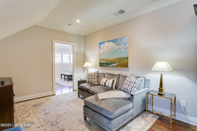 living room with hardwood / wood-style flooring, crown molding, and vaulted ceiling