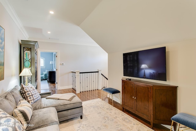 living room featuring crown molding, wood-type flooring, and vaulted ceiling