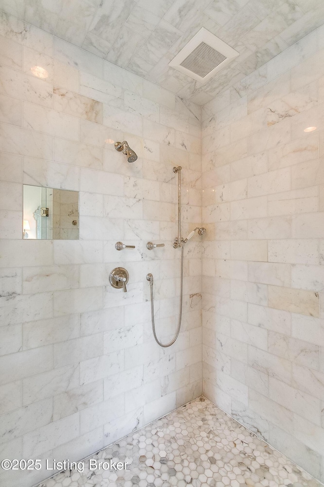 bathroom featuring a tile shower