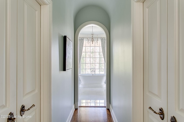 corridor featuring an inviting chandelier