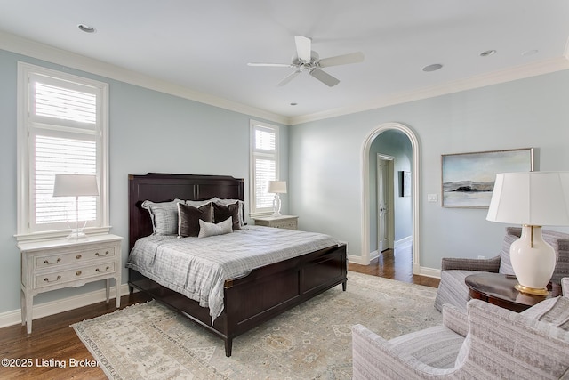 bedroom featuring hardwood / wood-style floors, ornamental molding, and ceiling fan