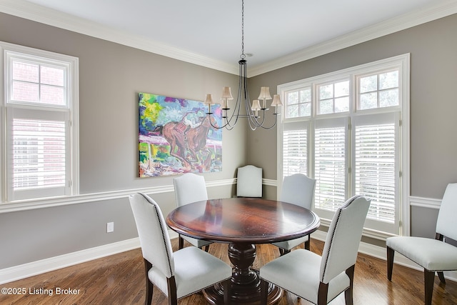 dining space with crown molding, dark wood-type flooring, and a chandelier