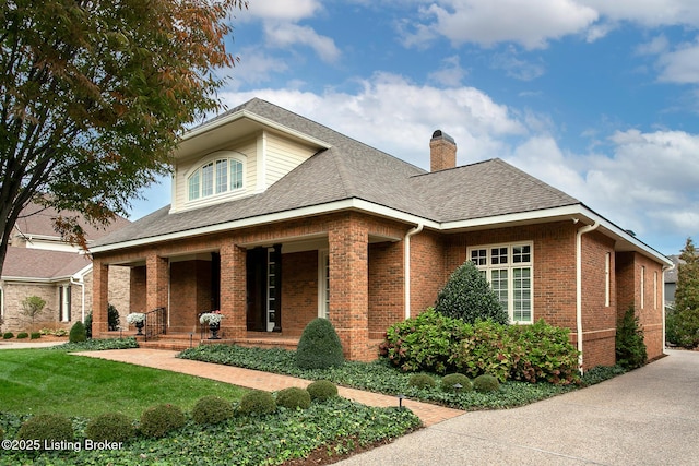 view of front of property with covered porch and a front lawn