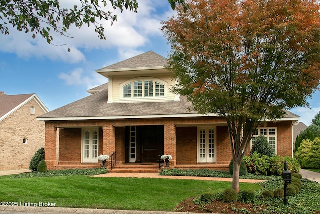 view of front of property with a porch and a front yard