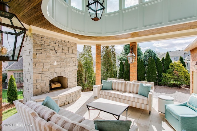 view of patio / terrace with an outdoor living space with a fireplace