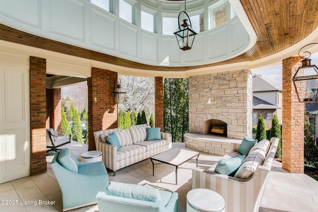 view of patio featuring an outdoor living space with a fireplace