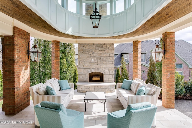 view of patio / terrace with an outdoor living space with a fireplace