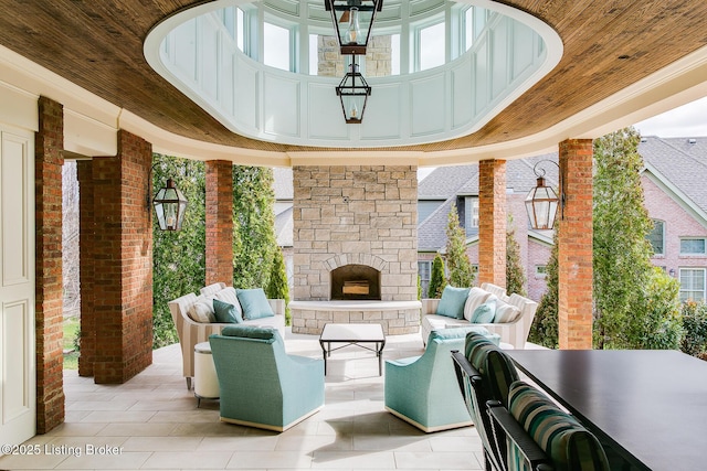 view of patio / terrace with an outdoor living space with a fireplace