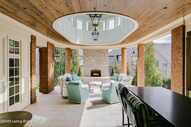 view of patio with an outdoor living space with a fireplace