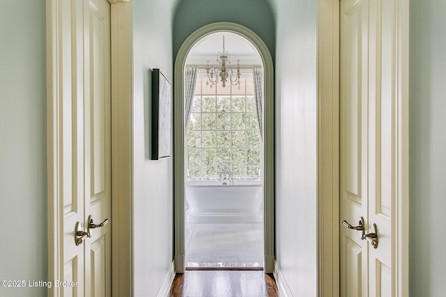 interior space featuring an inviting chandelier and wood-type flooring