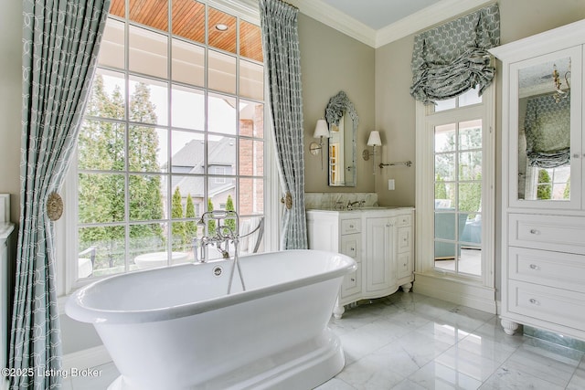 bathroom with ornamental molding, a bath, and vanity