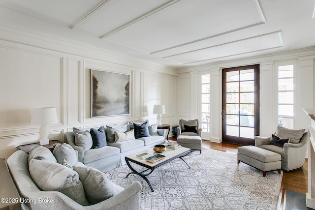 living room featuring crown molding and light hardwood / wood-style flooring