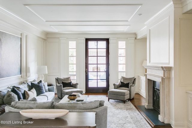 living room with crown molding and hardwood / wood-style floors