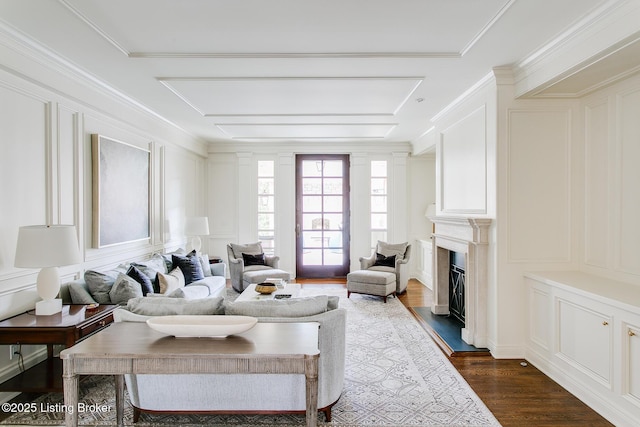 living room with crown molding and dark wood-type flooring