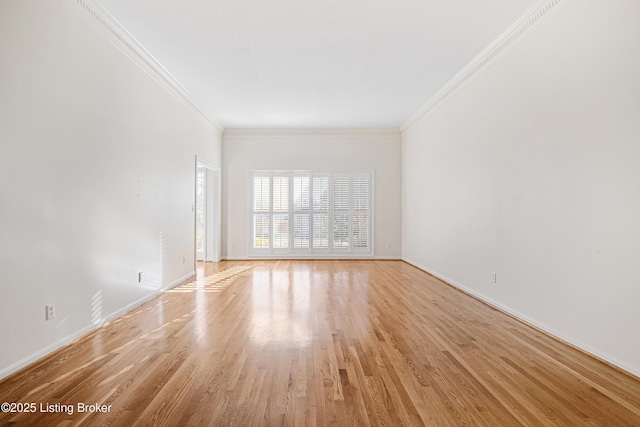 unfurnished room featuring ornamental molding and light wood-type flooring