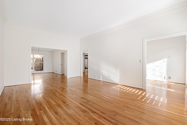 unfurnished room with crown molding, a chandelier, and light hardwood / wood-style floors