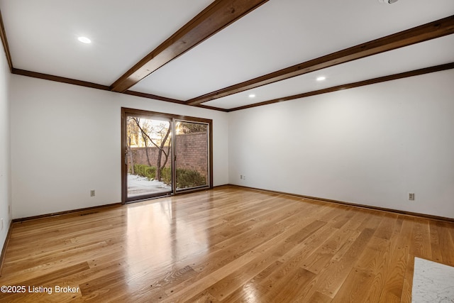 unfurnished room with beam ceiling and light hardwood / wood-style floors