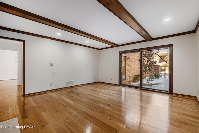 unfurnished room featuring beam ceiling and light wood-type flooring