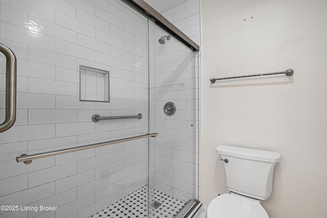 bathroom with toilet and an enclosed shower