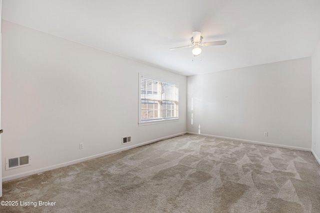 carpeted spare room with ceiling fan