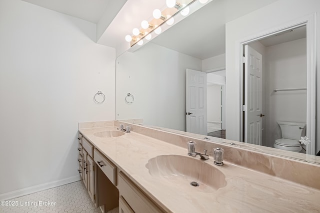 bathroom with vanity, tile patterned floors, and toilet