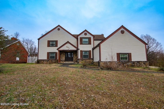 view of property featuring a front lawn