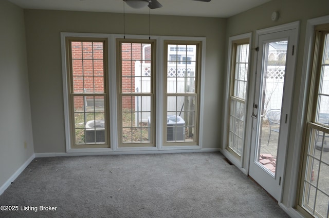 interior space with ceiling fan and light carpet