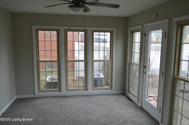 doorway to outside featuring light carpet and ceiling fan