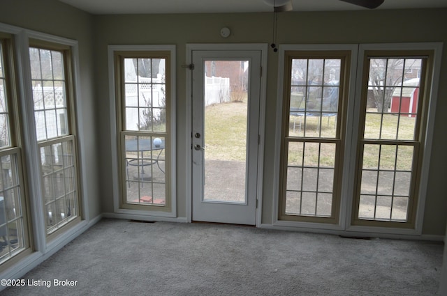 entryway with light colored carpet and ceiling fan