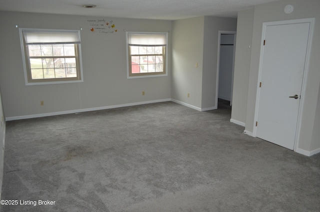 unfurnished room featuring light carpet