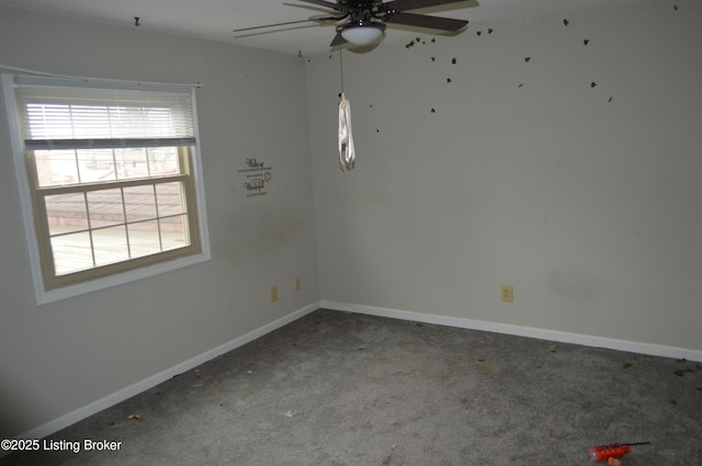 carpeted spare room featuring ceiling fan