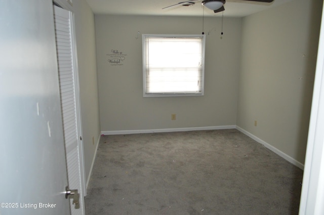 carpeted spare room with ceiling fan