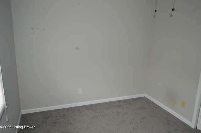 spare room featuring light colored carpet