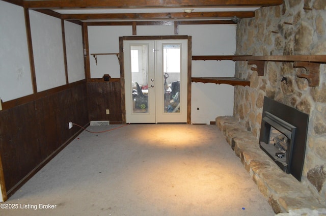 basement with a fireplace and french doors