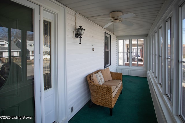 sunroom featuring ceiling fan